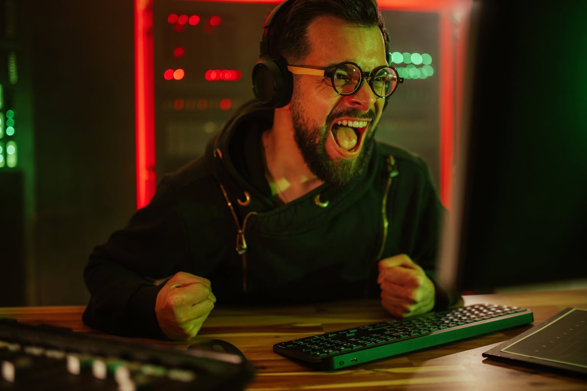 Enthusiastic male gamer celebrating victory